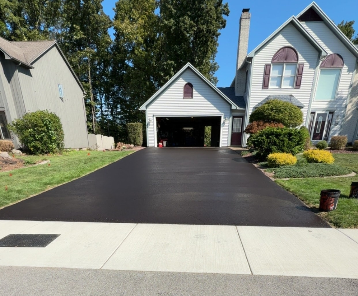 Asphera sealcoating crew working on a driveway in Monroe County NY